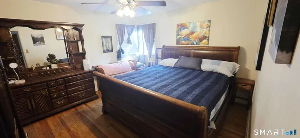 a bed room with a bed and a television