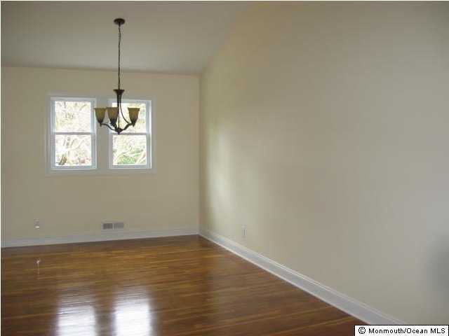 161 Newbury Road Howell, NJ 07731 - Photo 3 of 3 a view of a room with wooden floor and chandelier