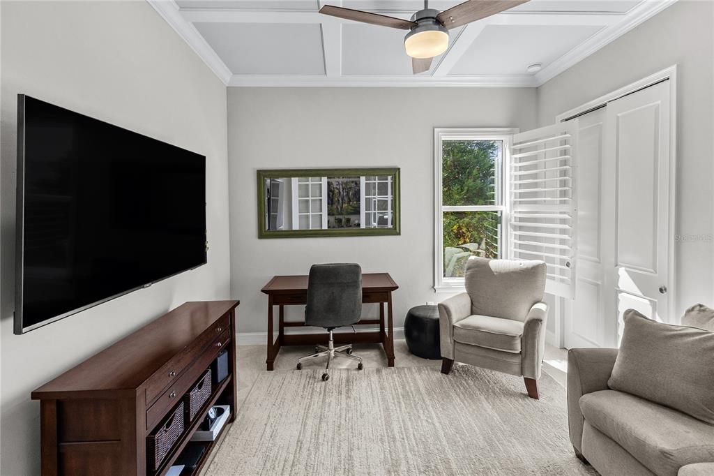 11075 Southwest 38th Boulevard Gainesville, FL 32608 - Photo 16 of 37 a living room with furniture and a flat screen tv