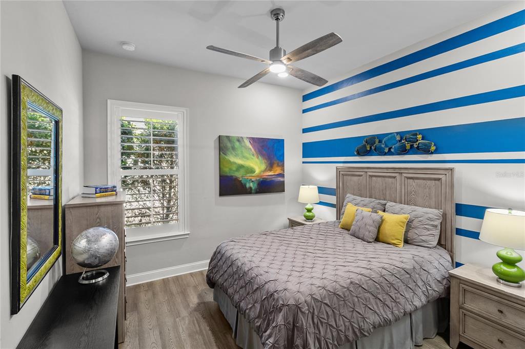 11075 Southwest 38th Boulevard Gainesville, FL 32608 - Photo 20 of 37 a bedroom with a bed and wooden floor