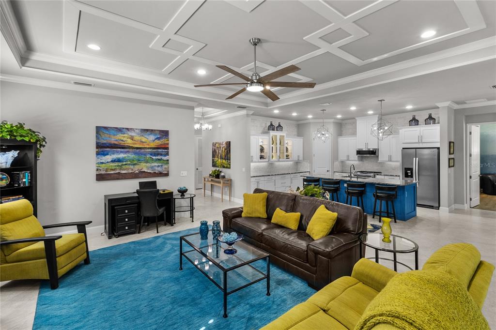 11075 Southwest 38th Boulevard Gainesville, FL 32608 - Photo 23 of 37 a living room with furniture kitchen view and a flat screen tv
