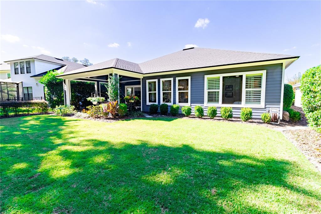 11075 Southwest 38th Boulevard Gainesville, FL 32608 - Photo 25 of 37 a front view of a house with a yard and porch