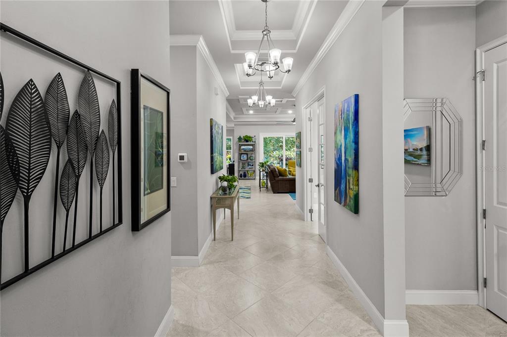 11075 Southwest 38th Boulevard Gainesville, FL 32608 - Photo 6 of 37 a view of a hallway with windows and chandelier