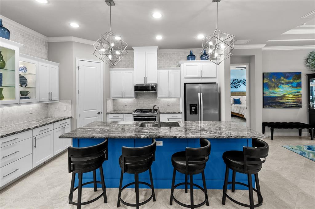 11075 Southwest 38th Boulevard Gainesville, FL 32608 - Photo 9 of 37 a kitchen with cabinets a counter and chairs