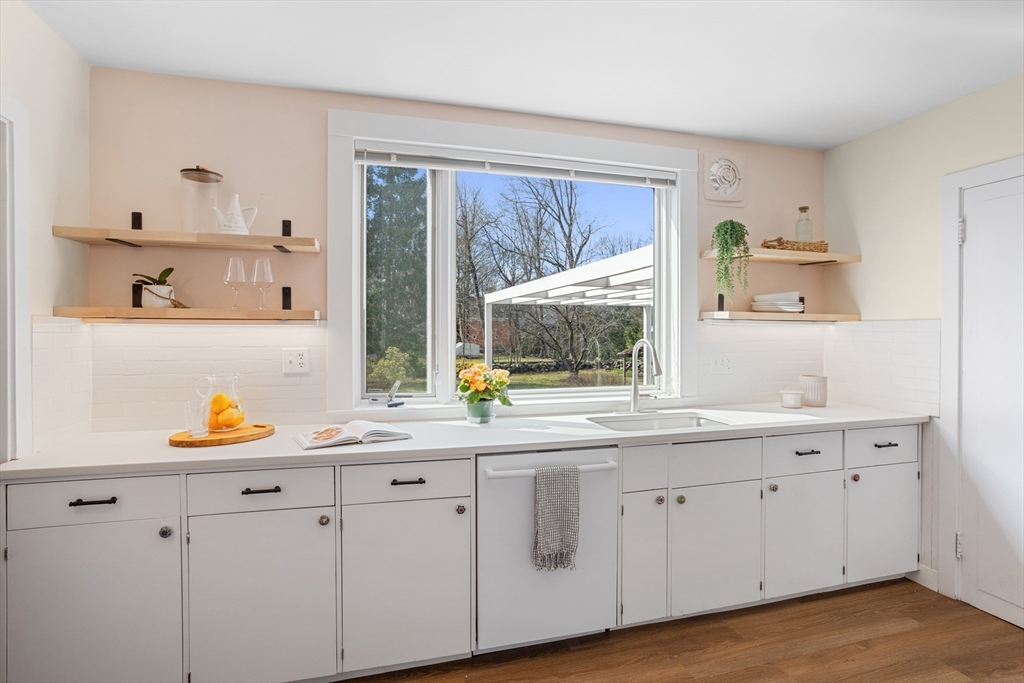 34 Fletcher Road Bedford, MA 01730 - Photo 11 of 42 a kitchen with white cabinets and window