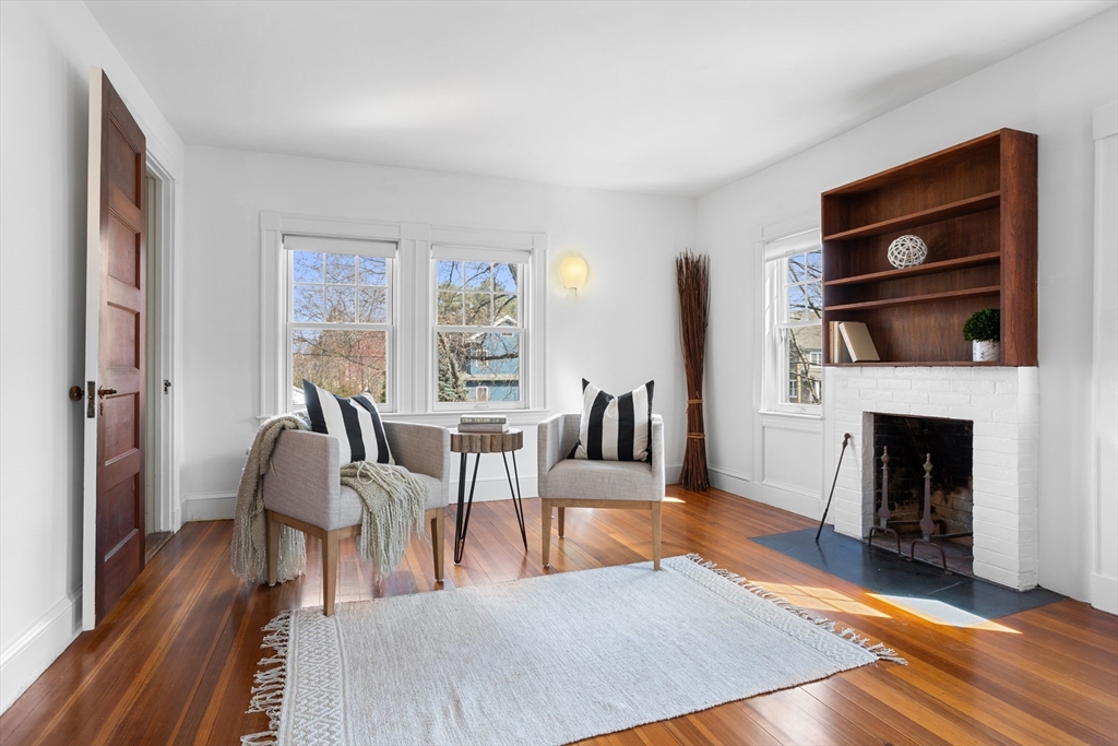 34 Fletcher Road Bedford, MA 01730 - Photo 22 of 42 a living room with furniture a fireplace and a flat screen tv