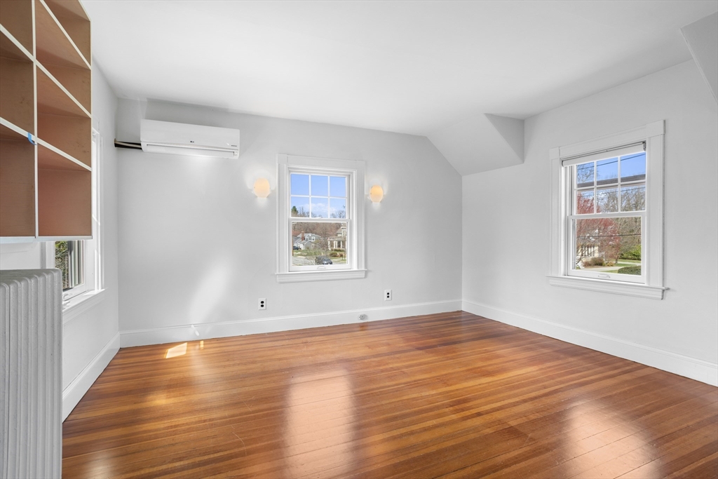 34 Fletcher Road Bedford, MA 01730 - Photo 26 of 42 a view of empty room with wooden floor and fan