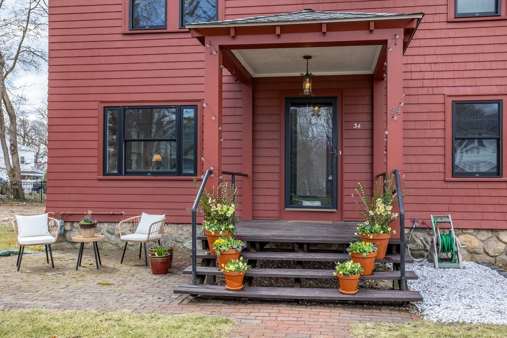 34 Fletcher Road Bedford, MA 01730 - Photo 30 of 42 a front view of a house with outdoor seating and plants