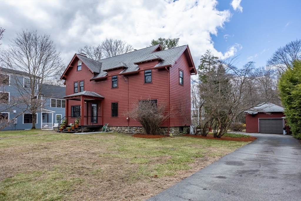 34 Fletcher Road Bedford, MA 01730 - Photo 36 of 42 a view of a big house with a big yard and large trees