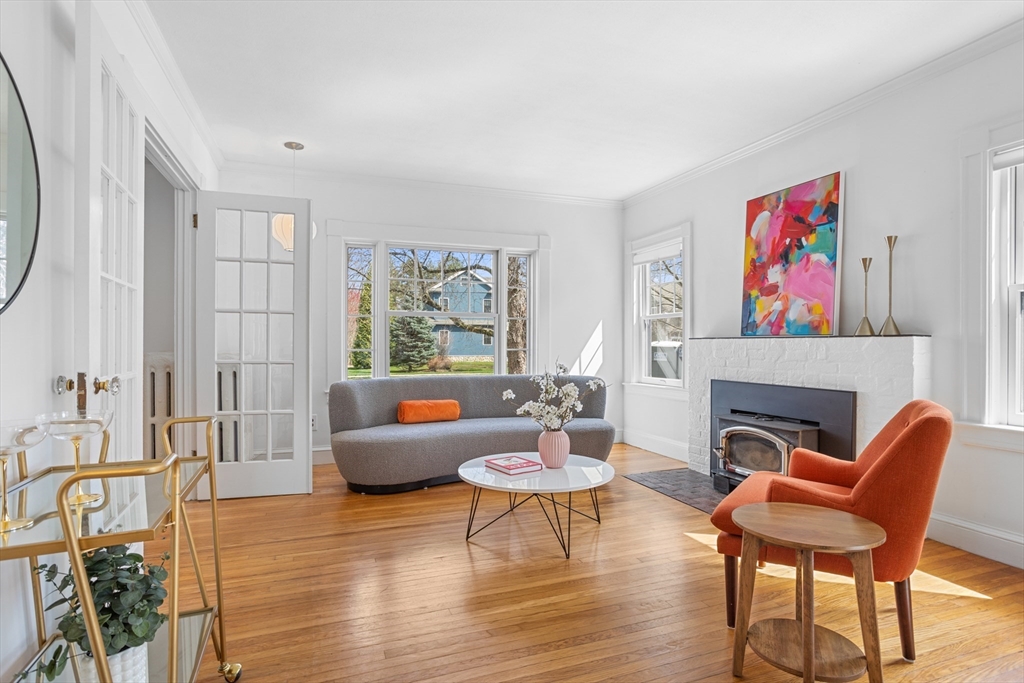 34 Fletcher Road Bedford, MA 01730 - Photo 5 of 42 a living room with furniture a fireplace and a large window