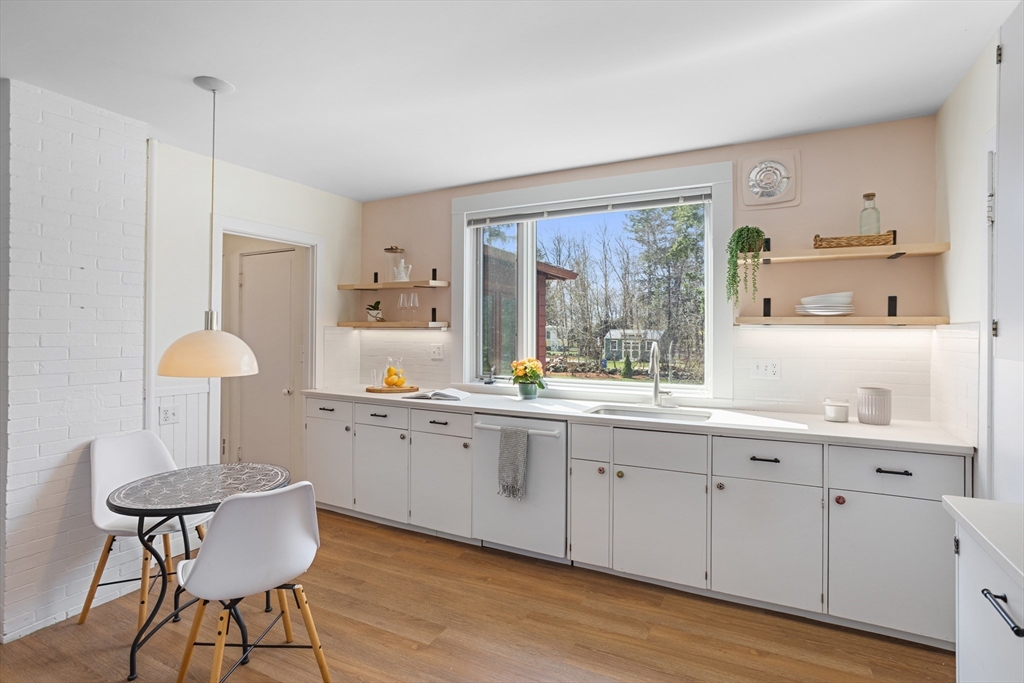34 Fletcher Road Bedford, MA 01730 - Photo 8 of 42 a kitchen with sink cabinets and wooden floor