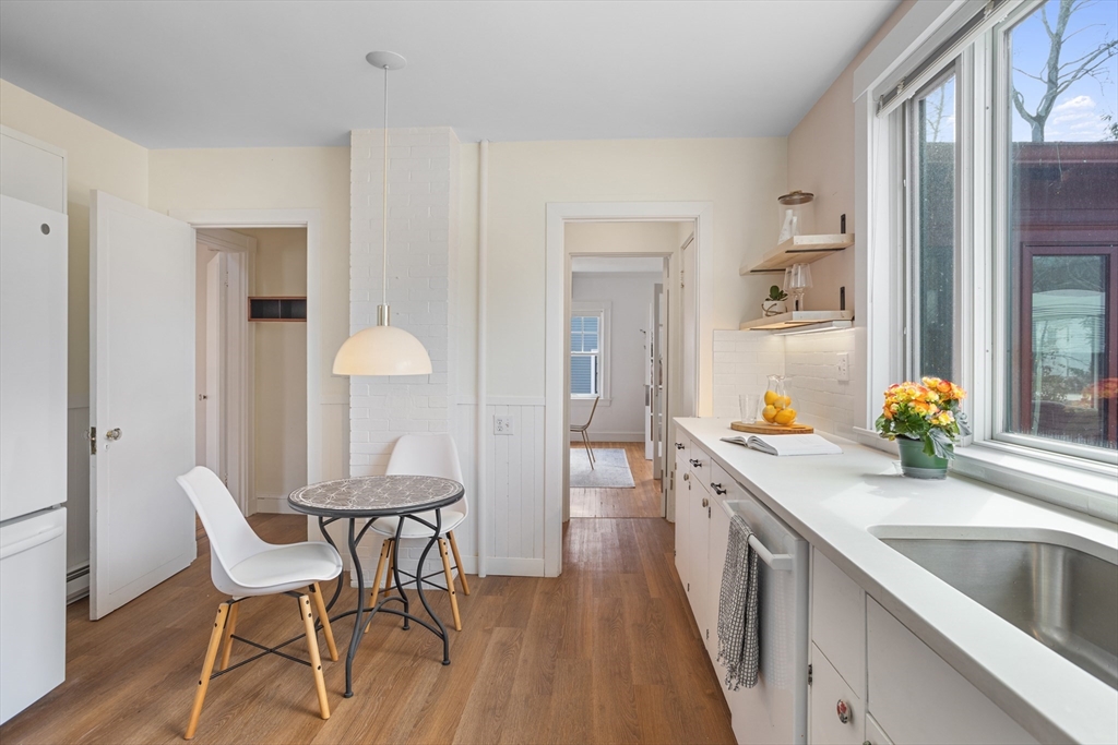 34 Fletcher Road Bedford, MA 01730 - Photo 9 of 42 a kitchen with a table chairs and a sink