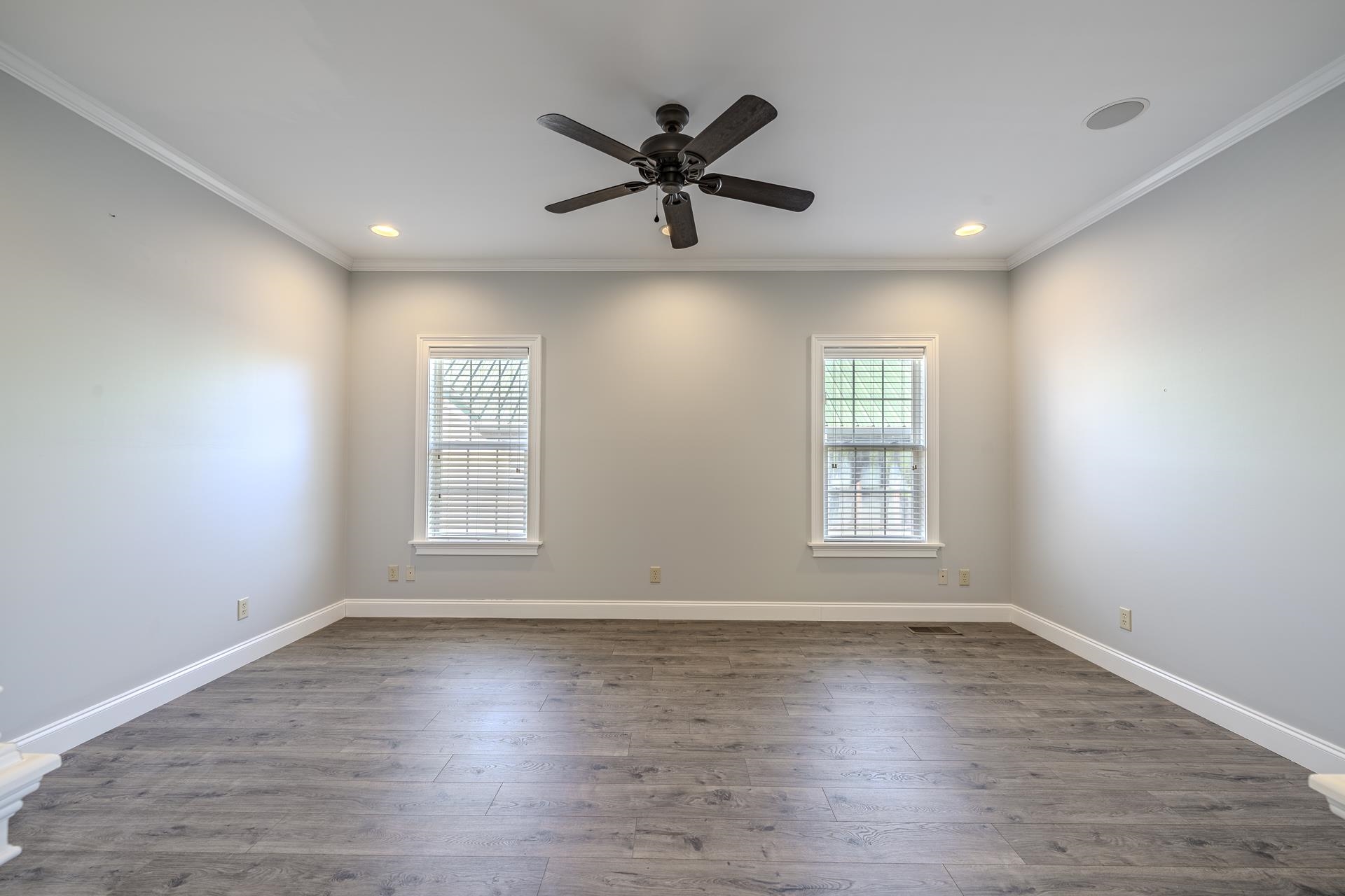 9 Mountain View Iuka, MS 38852 - Photo 12 of 32 Empty room featuring dark wood-style flooring, a ceiling fan, and ornamental molding