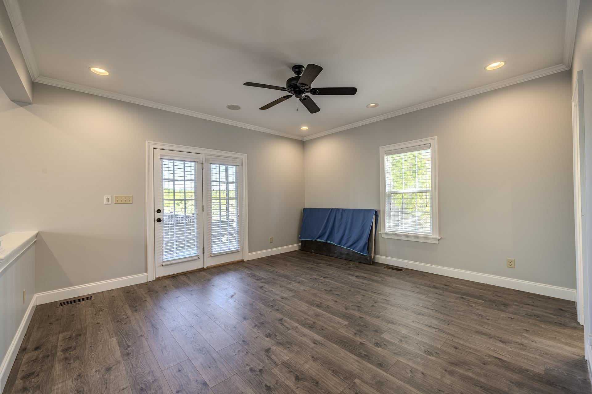9 Mountain View Iuka, MS 38852 - Photo 15 of 32 Empty room featuring healthy amount of natural light, ceiling fan, dark wood-type flooring, ornamental molding, and recessed lighting