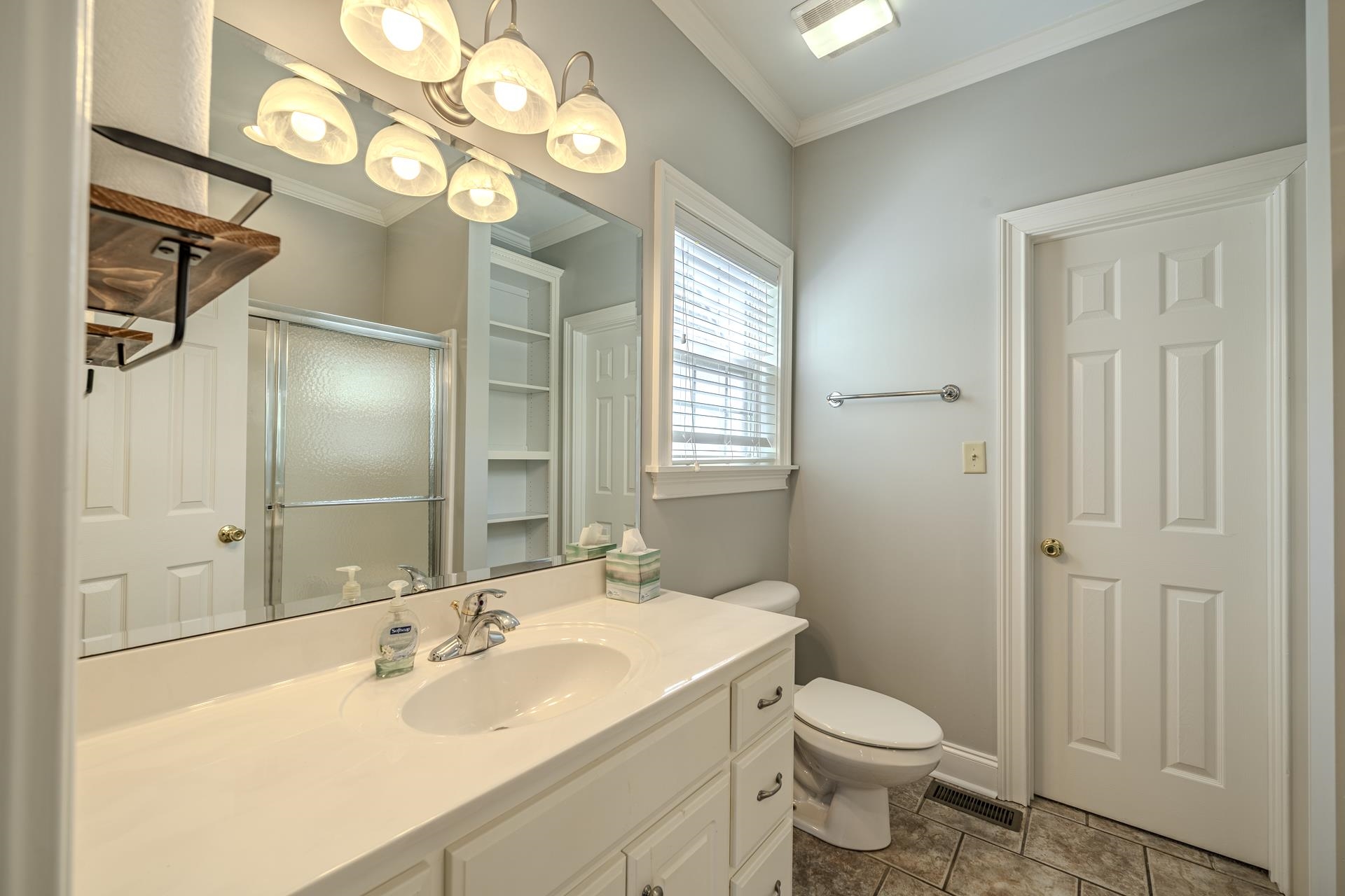9 Mountain View Iuka, MS 38852 - Photo 17 of 32 Full bathroom featuring vanity, ornamental molding, a shower stall, and dark tile patterned flooring