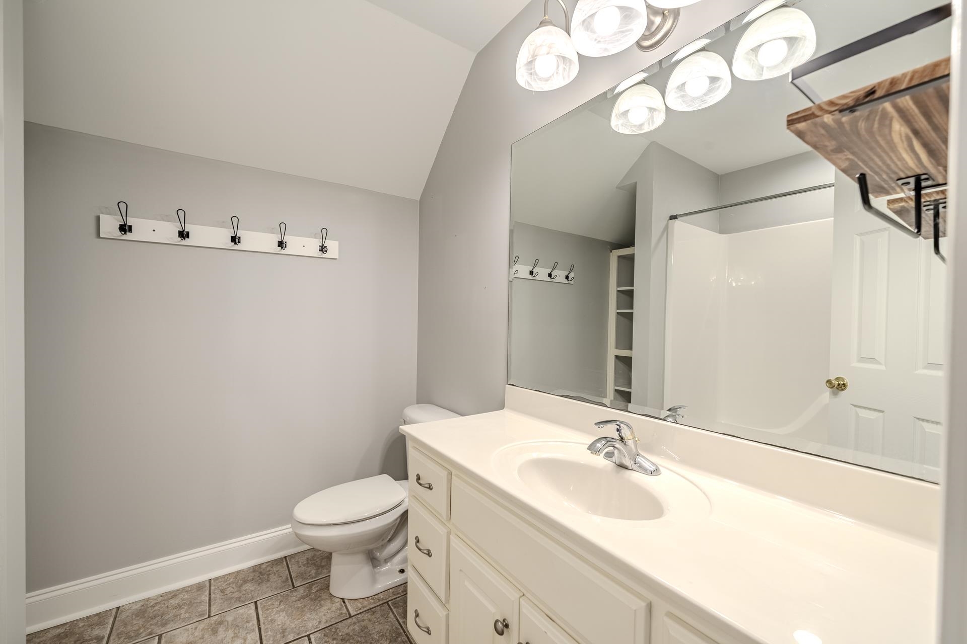 9 Mountain View Iuka, MS 38852 - Photo 21 of 32 Full bath with vanity, light tile patterned floors, vaulted ceiling, and a shower