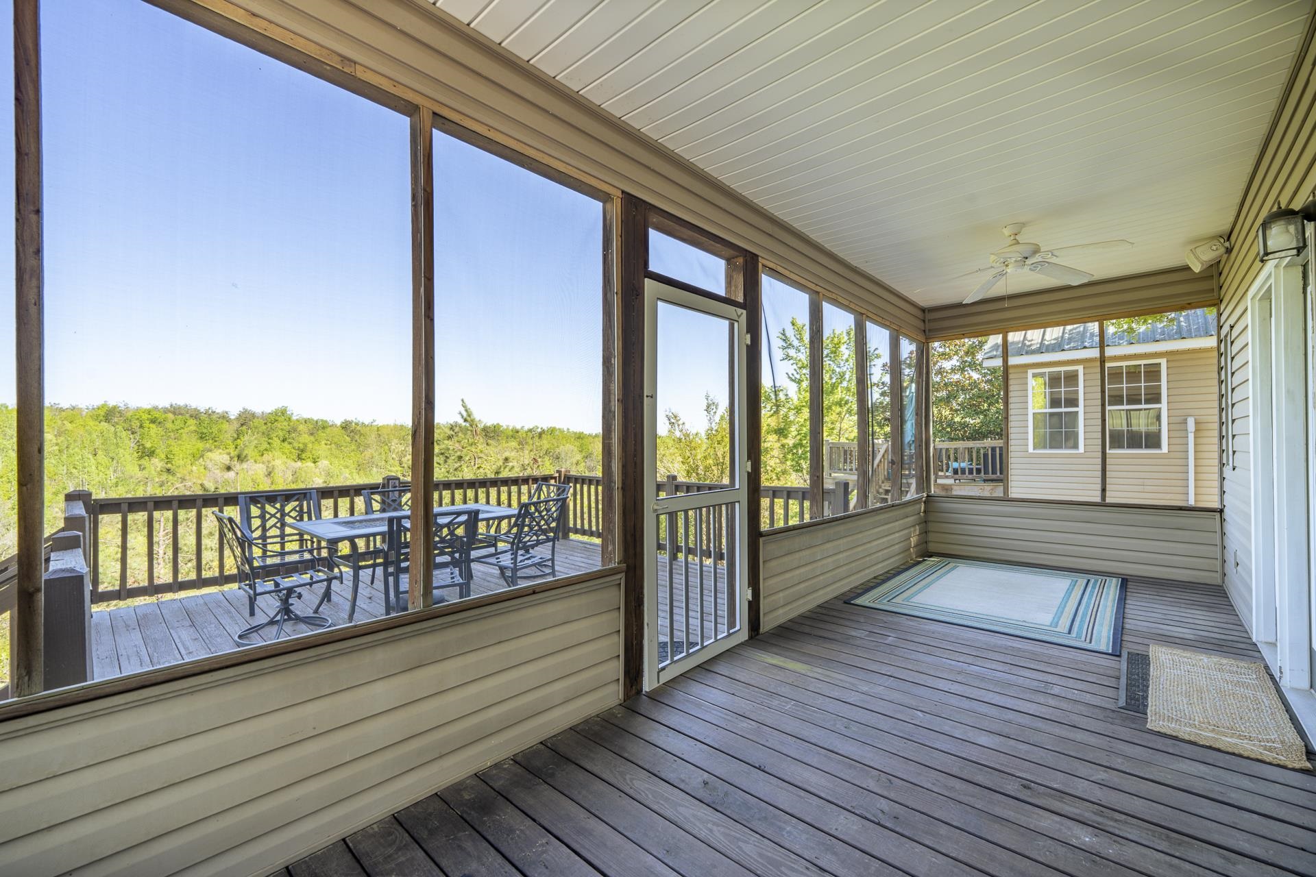 9 Mountain View Iuka, MS 38852 - Photo 24 of 32 Unfurnished sunroom with outdoor dining space, ceiling fan, and a deck