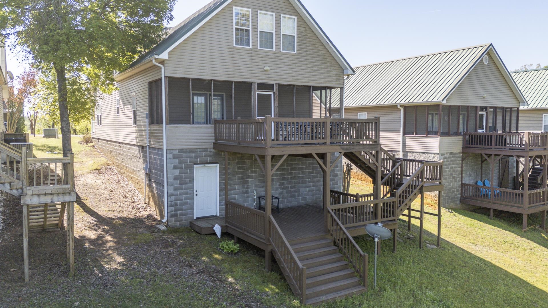 9 Mountain View Iuka, MS 38852 - Photo 26 of 32 Rear view of house with a sunroom, a deck, and a yard