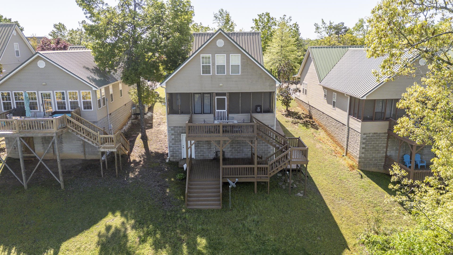 9 Mountain View Iuka, MS 38852 - Photo 27 of 32 Rear view of house featuring a sunroom, a wooden deck, and a yard