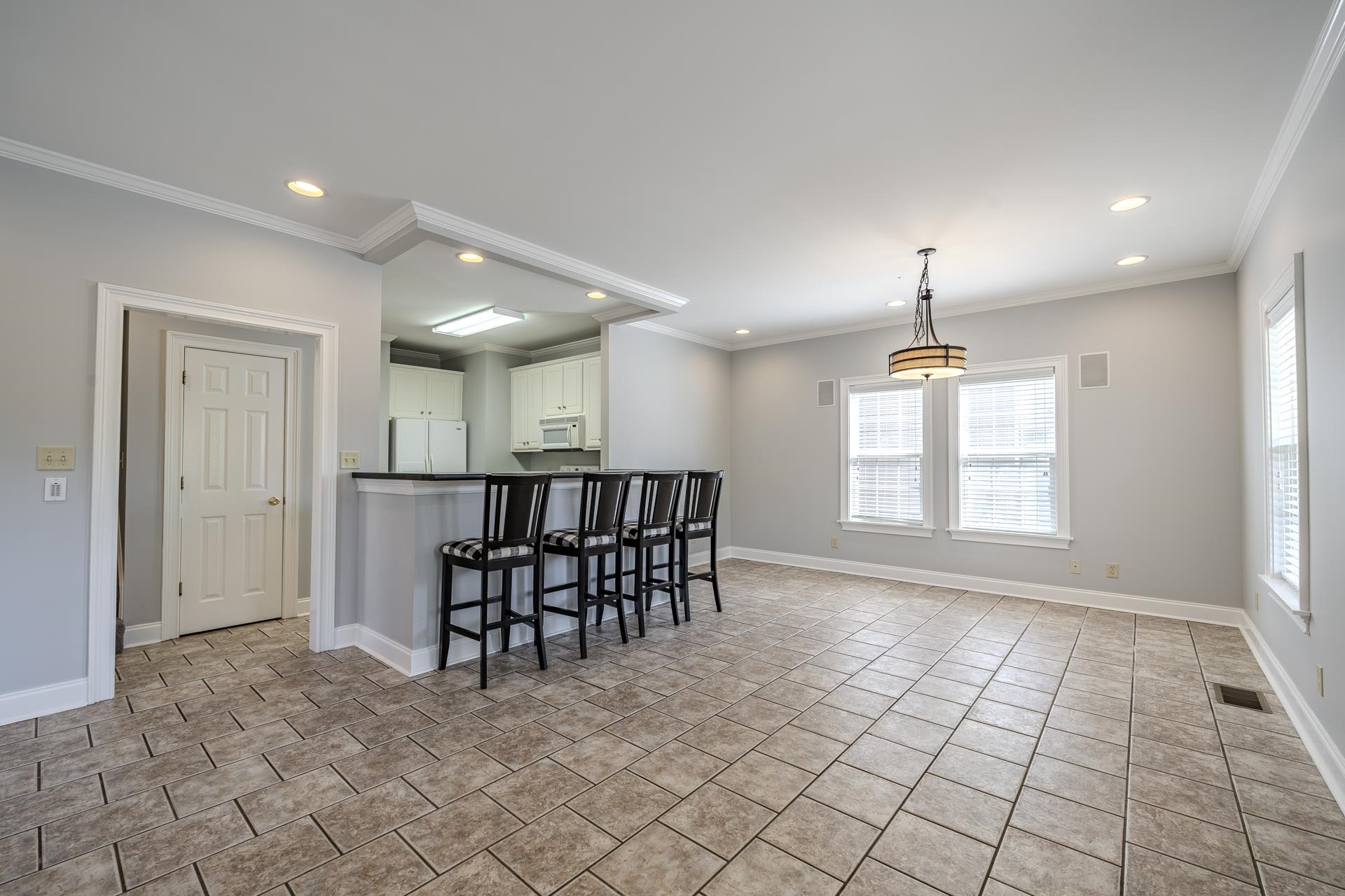 9 Mountain View Iuka, MS 38852 - Photo 5 of 32 Kitchen featuring dark countertops, a breakfast bar area, plenty of natural light, white appliances, and crown molding