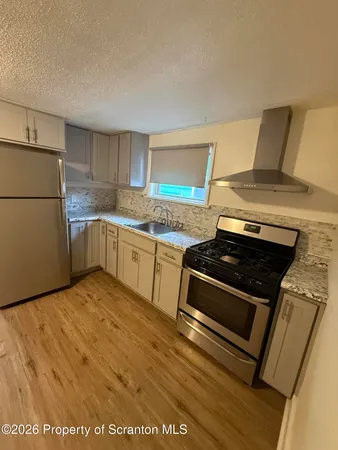 a kitchen with a stove and a refrigerator