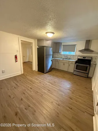 a view of a kitchen with a sink and a stove