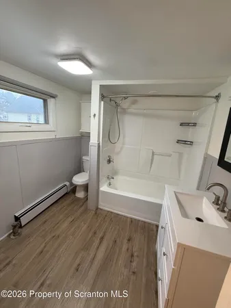 a bathroom with a sink a toilet and a bathtub