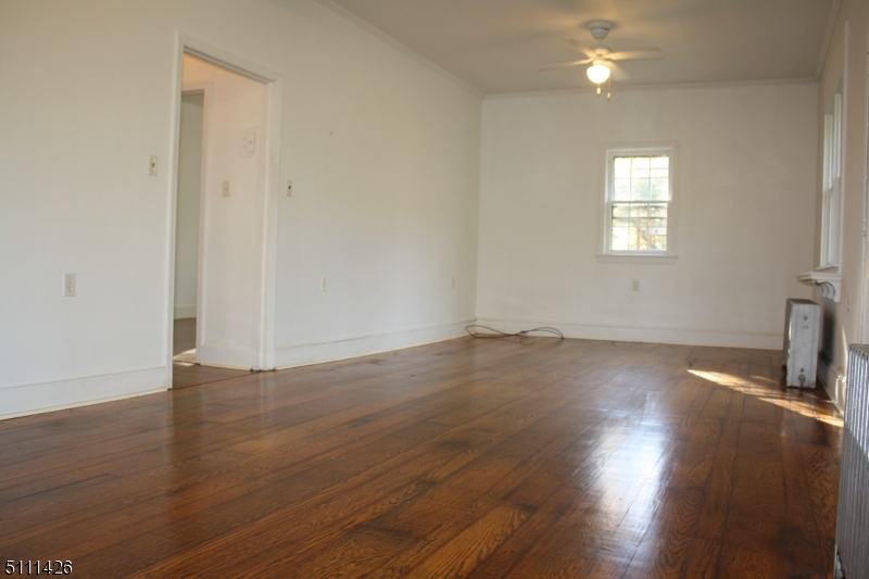 245 Millbrook Road Washington, NJ 07882 - Photo 14 of 34 an empty room with wooden floor and windows
