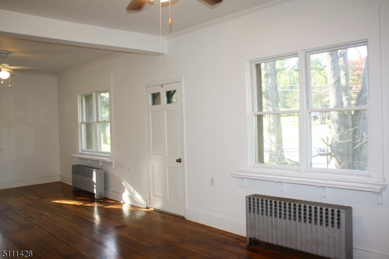 245 Millbrook Road Washington, NJ 07882 - Photo 15 of 34 a view of an empty room with wooden floor and a window