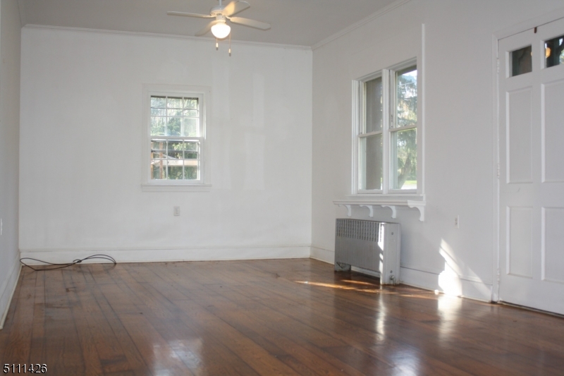 245 Millbrook Road Washington, NJ 07882 - Photo 16 of 34 an empty room with wooden floor and windows