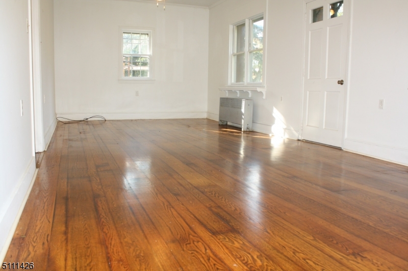245 Millbrook Road Washington, NJ 07882 - Photo 18 of 34 an empty room with wooden floor and windows