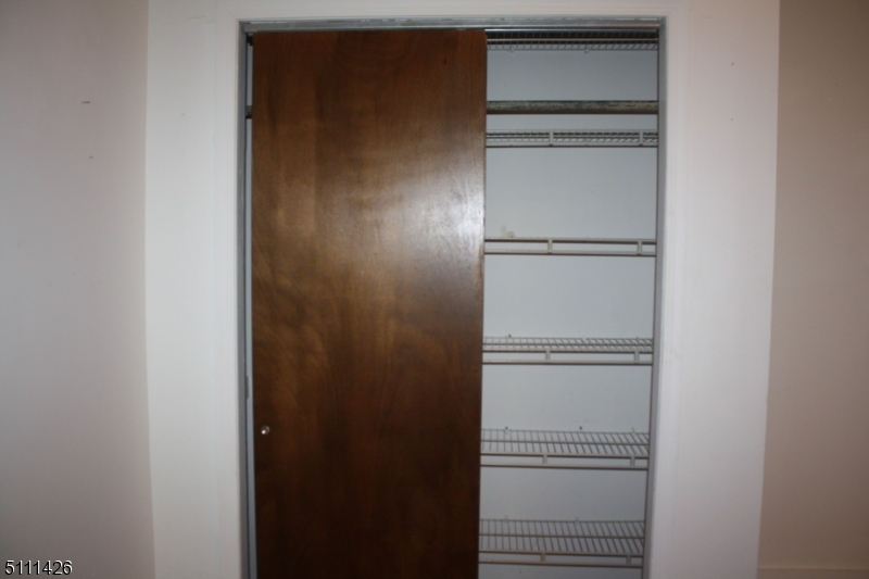 245 Millbrook Road Washington, NJ 07882 - Photo 21 of 34 a view of walk in closet with empty racks
