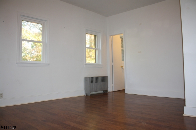 245 Millbrook Road Washington, NJ 07882 - Photo 23 of 34 an empty room with wooden floor and windows