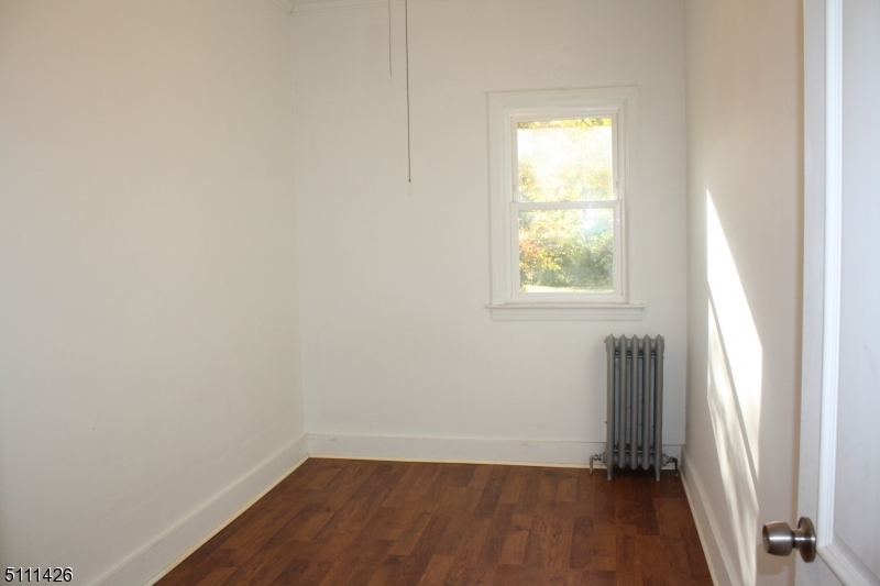 245 Millbrook Road Washington, NJ 07882 - Photo 28 of 34 an empty room with wooden floor and a window