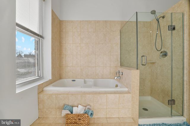 a bathroom with a bathtub and a shower