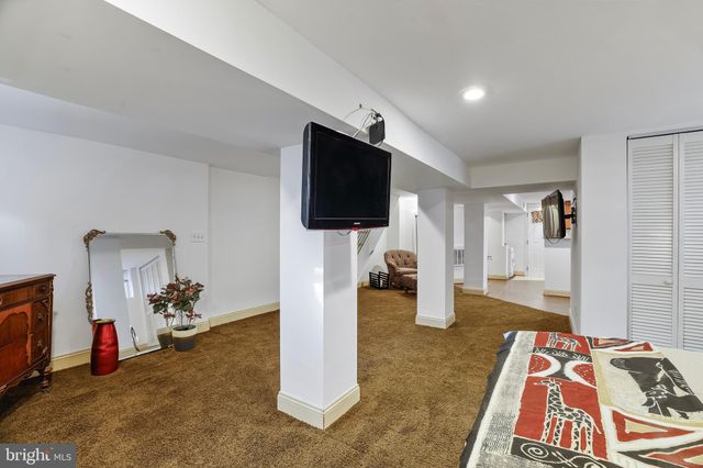 a bedroom with furniture and a flat screen tv