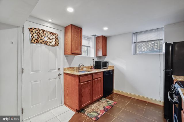 a kitchen with stainless steel appliances granite countertop a stove a refrigerator and a microwave