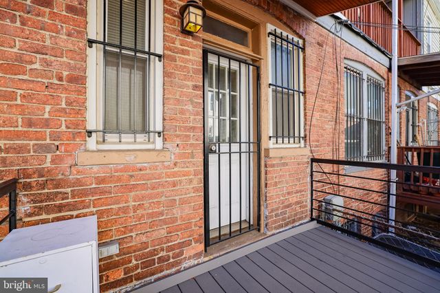 a view of a brick buildings with entryway and wooden floor