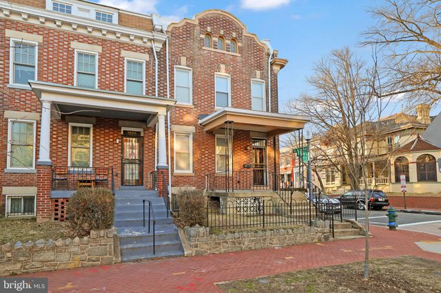 a front view of a building with a garden
