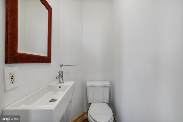 a white toilet sitting next to a bathroom sink