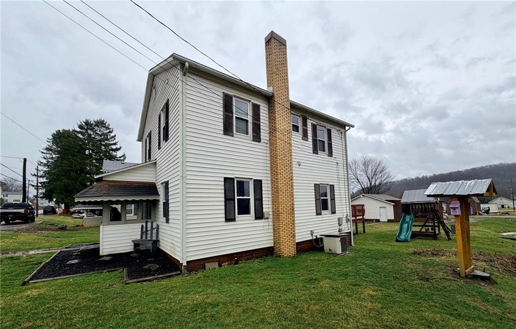 1408 State Rte 1042 Nu Mine, PA 16244 - Photo 4 of 19 a front view of a house with a garden