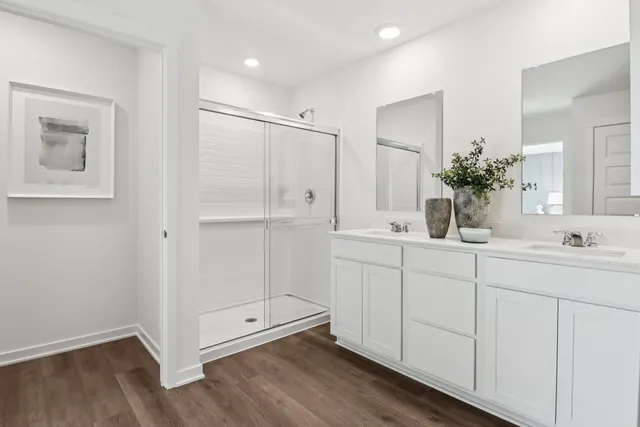 a bathroom with a double vanity sink and mirror
