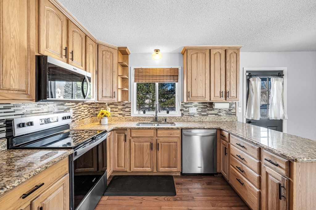 315 East Street South Suffield, CT 06078 - Photo 8 of 31 a kitchen with stainless steel appliances granite countertop a sink stove and refrigerator