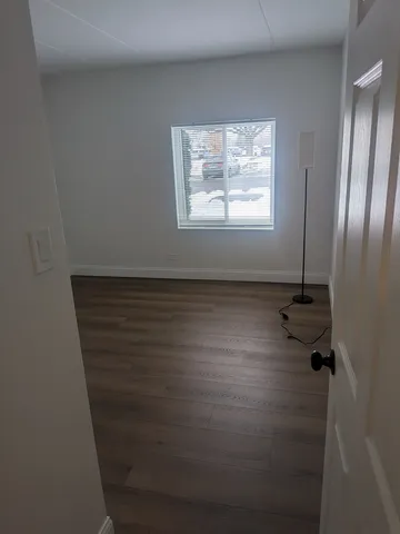 a view of an empty room with a fireplace