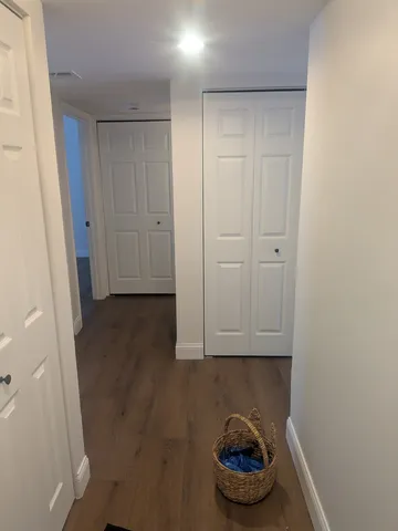 a room with a bench and cabinets