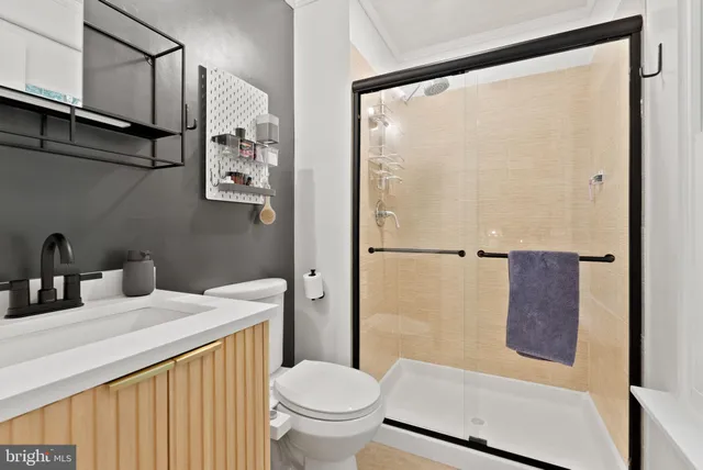 a bathroom with a granite countertop sink toilet and shower