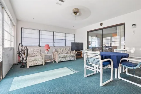 a bedroom with furniture and a large window