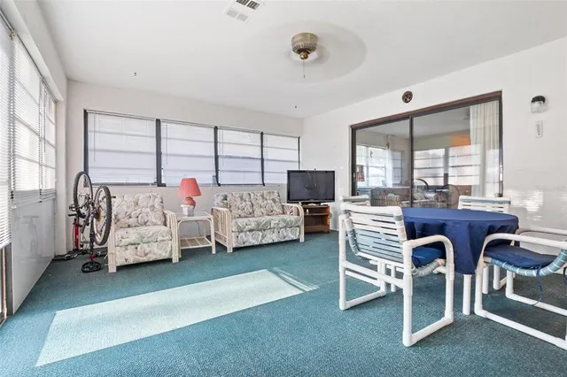 a bedroom with furniture and a large window