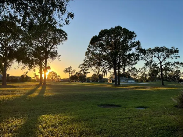 a view of outdoor space with green field and trees