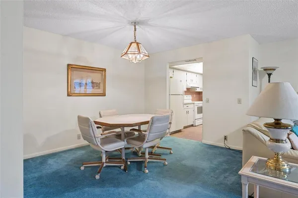a view of a dining room with furniture wooden floor and a chandelier